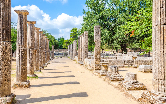 Ancient stone columns at the archaeological site of Ancient Olympia, Greece.