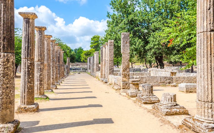Ancient stone columns at the archaeological site of Ancient Olympia, Greece.