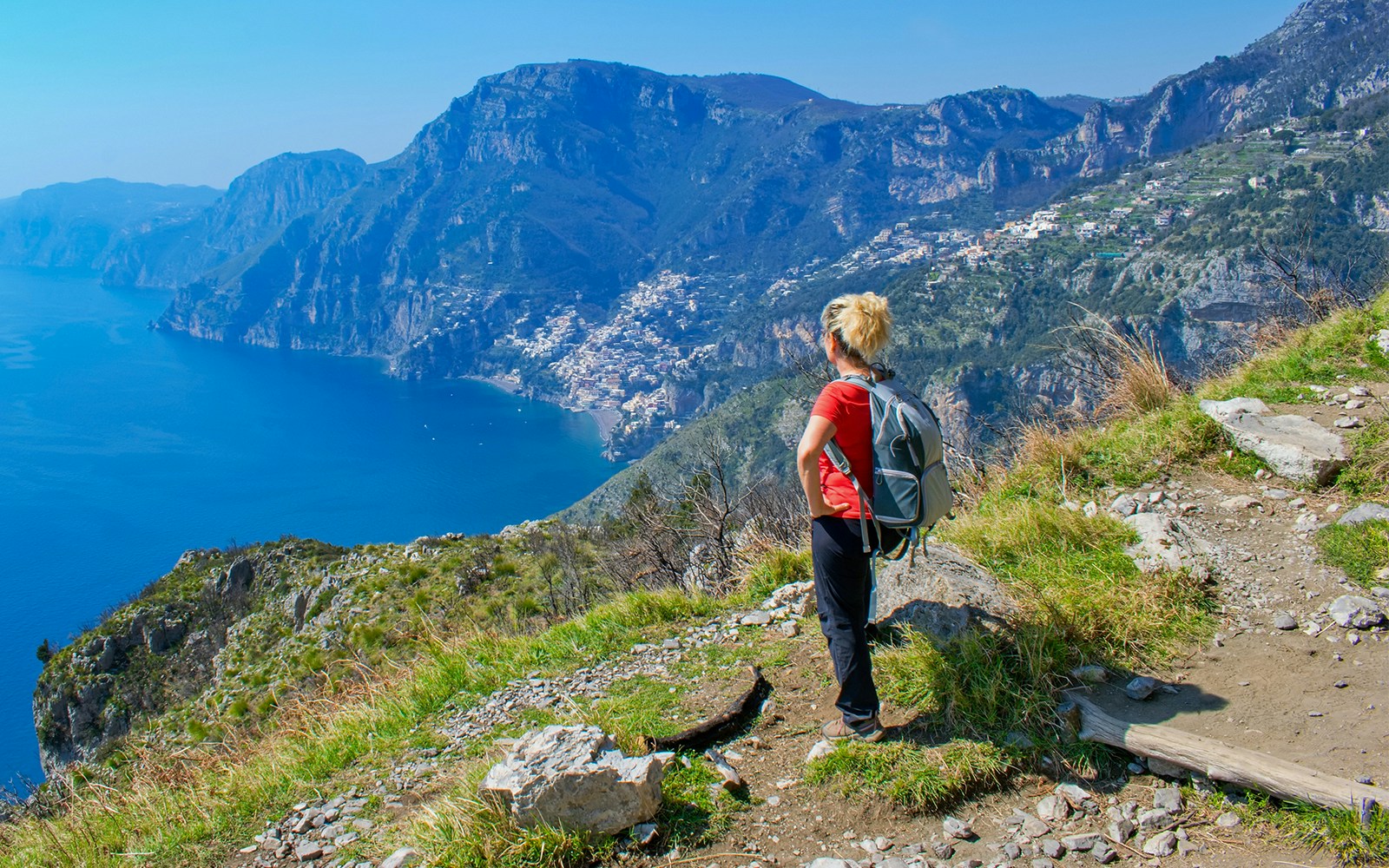 Hikers on Sentiero degli Dei trail overlooking Amalfi Coast, Italy.