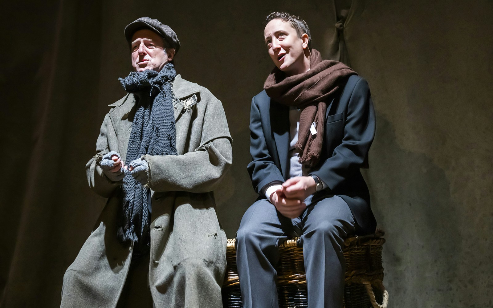 Actors performing a scene from "The Woman in Black" on stage.