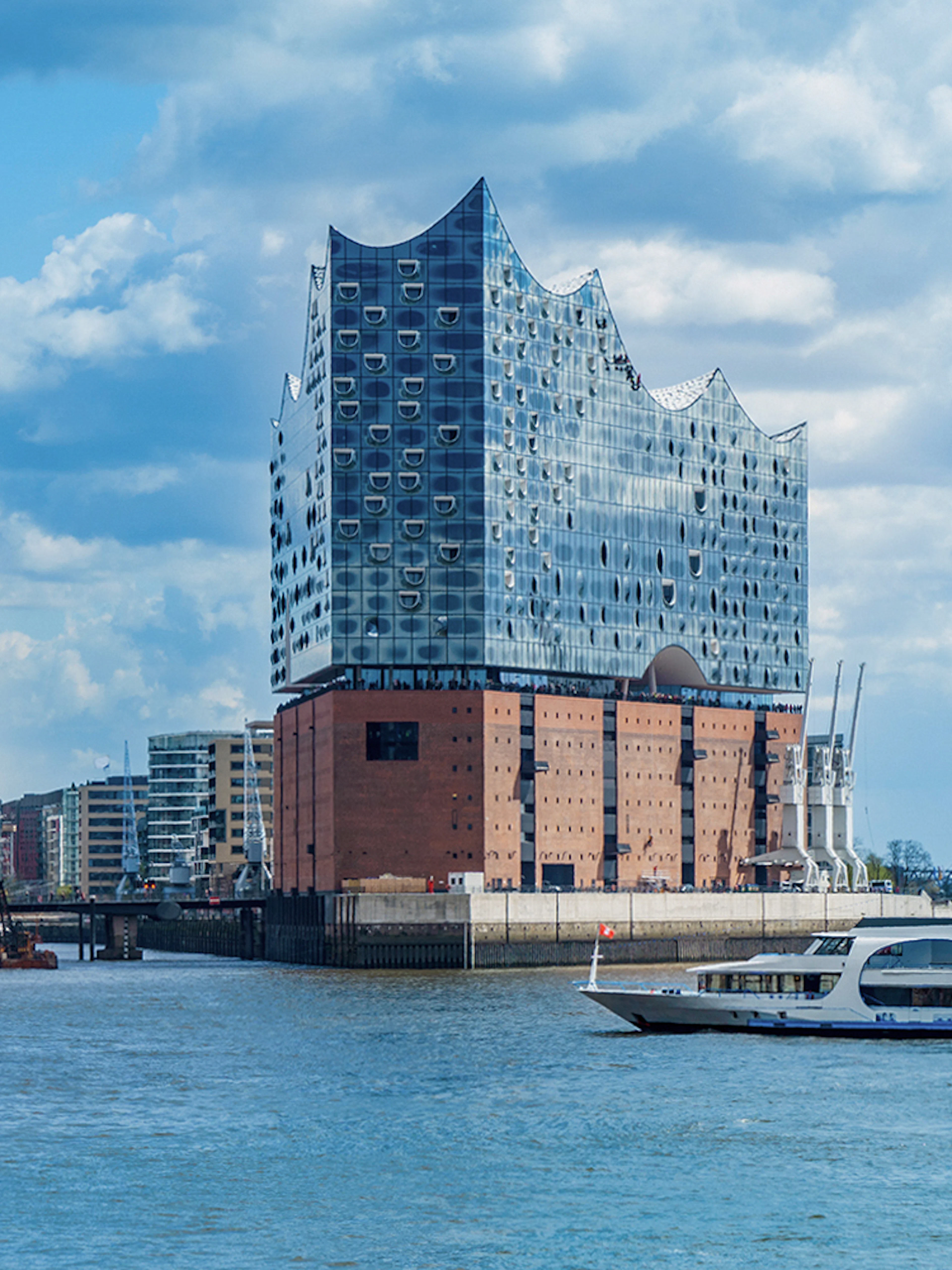 Elbphilharmonie concert hall in Hamburg with boats on the Elbe River.