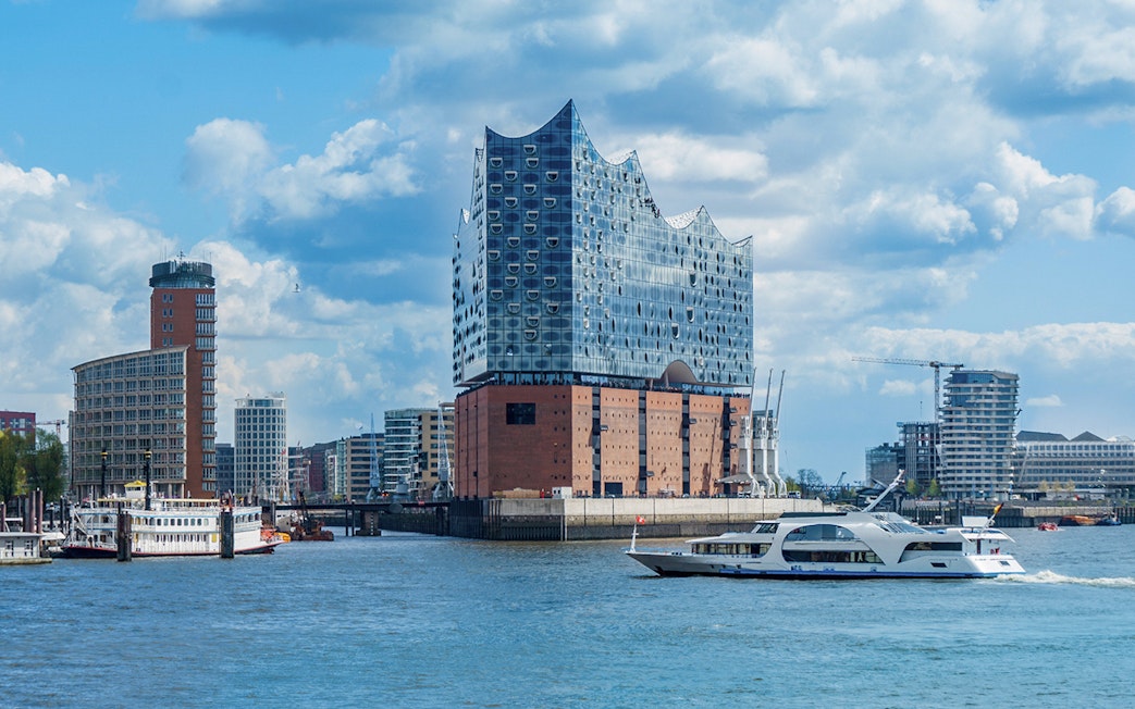 Elbphilharmonie concert hall in Hamburg with boats on the Elbe River.