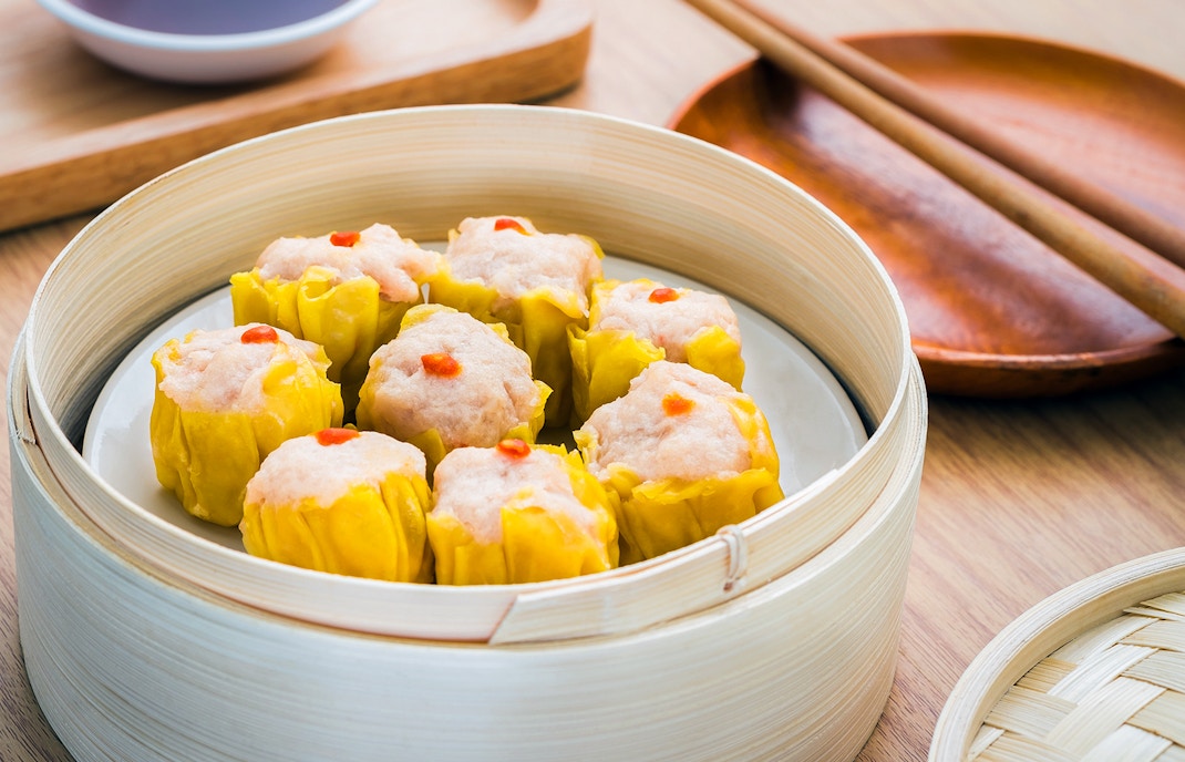 Steamed dumplings in bamboo steamer basket, a cantonese food delicacy