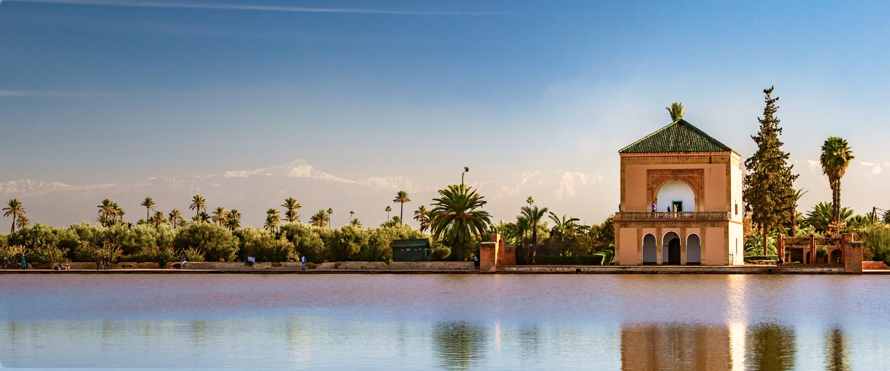 Menara Gardens pavilion with Atlas Mountains in Marrakech, Morocco.