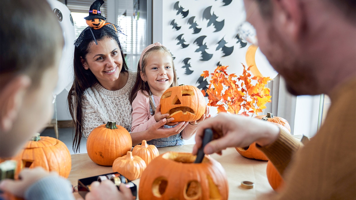 Halloween festival celebration with carved pumpkins and decorations in a vibrant street setting.