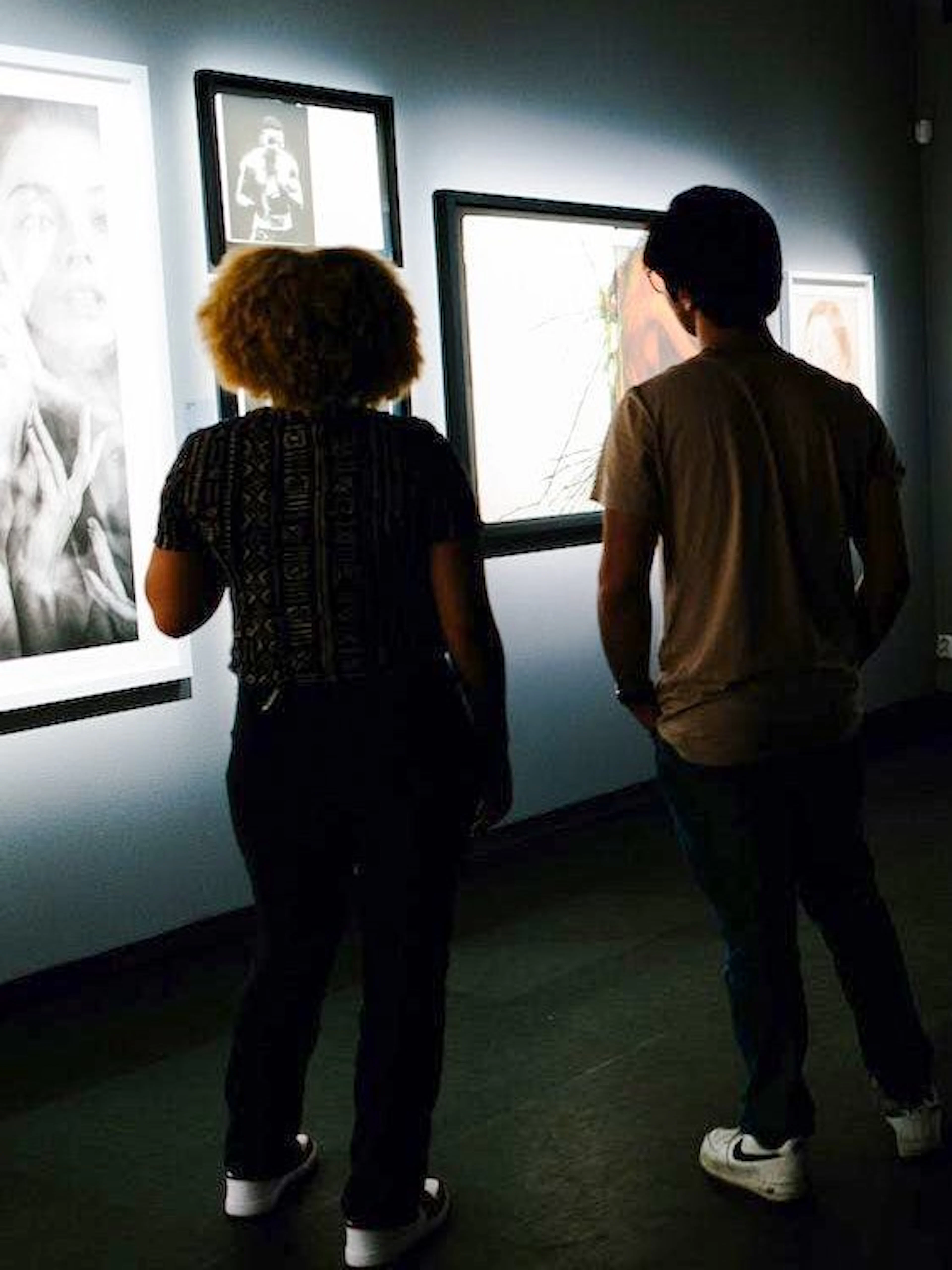 Visitors viewing art exhibits inside Fotografiska Berlin.