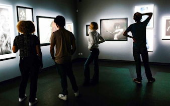 Visitors viewing art exhibits inside Fotografiska Berlin.