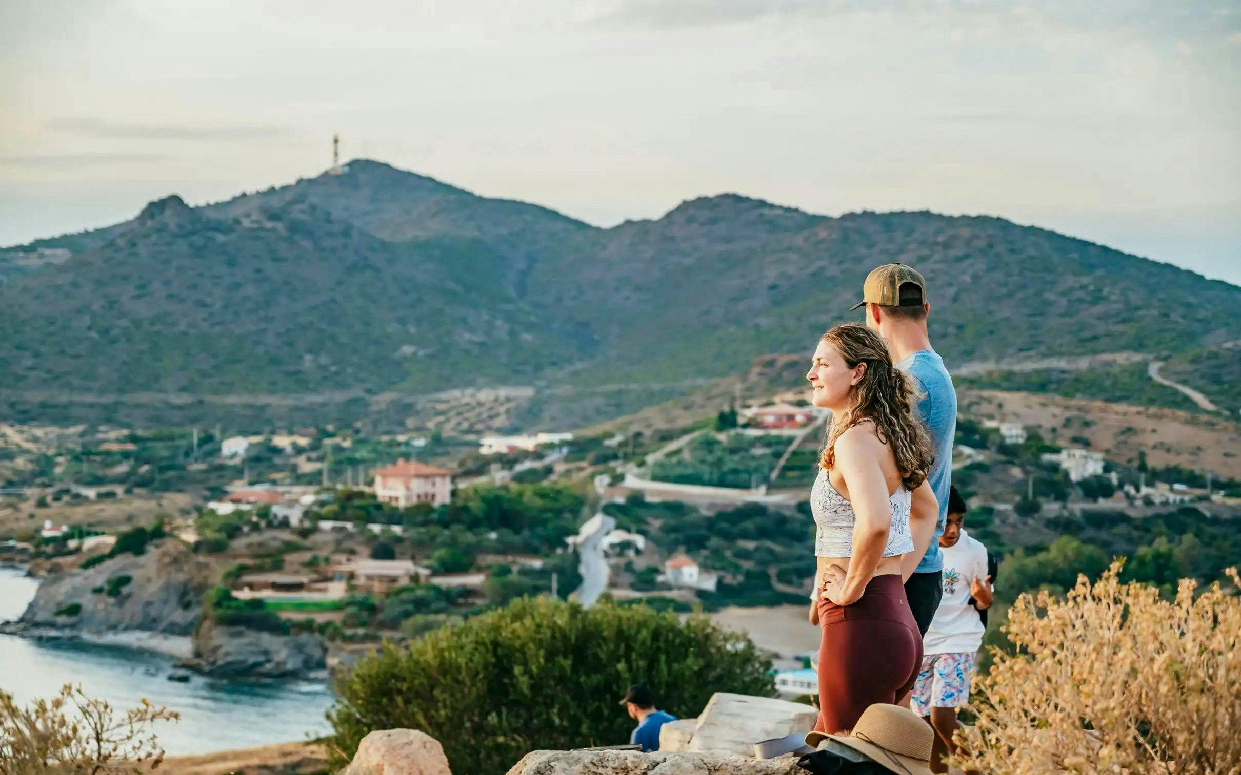 Tourists enjoying the view at Cape Sounion near the Temple of Poseidon, Greece.