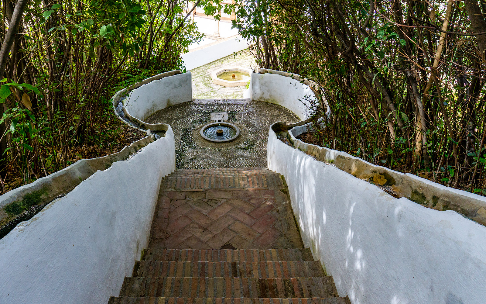 Generalife Gardens water stairway with lush greenery in Alhambra, Granada, Spain.