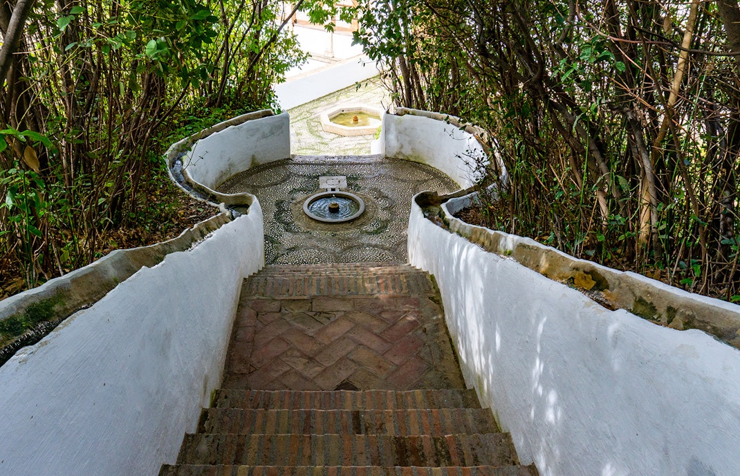 Generalife Gardens water stairway with lush greenery in Alhambra, Granada, Spain.