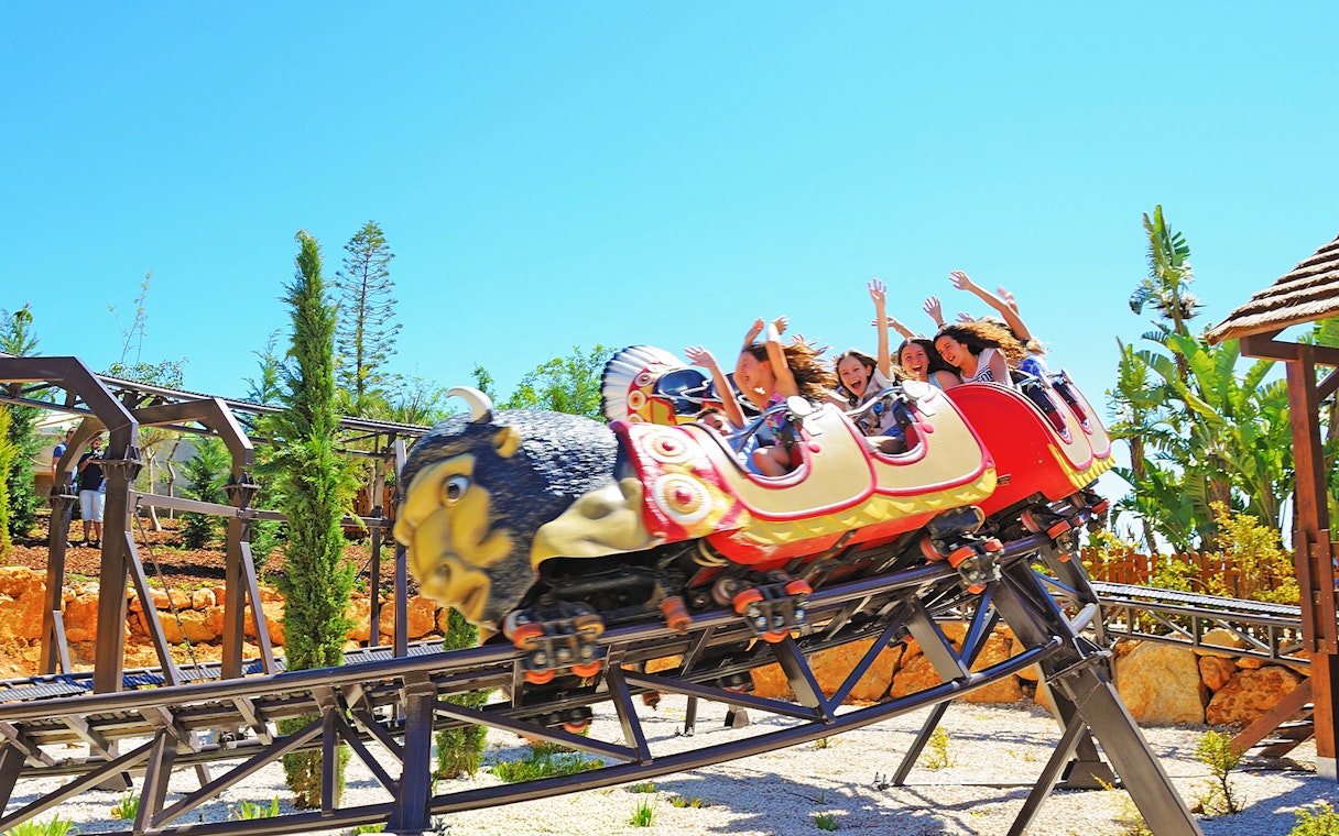 Roller coaster ride with people at Zoomarine Algarve.