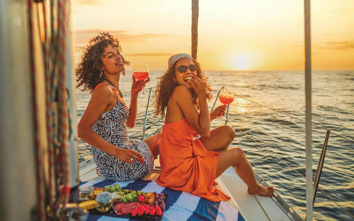Sunset sailing in Albufeira with drinks and snacks on a yacht deck.