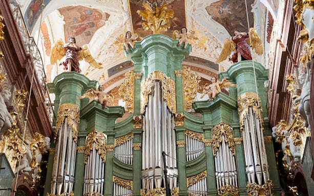 Jasna Gora Monastery's ornate pipe organ with angelic sculptures, Czestochowa, Poland.