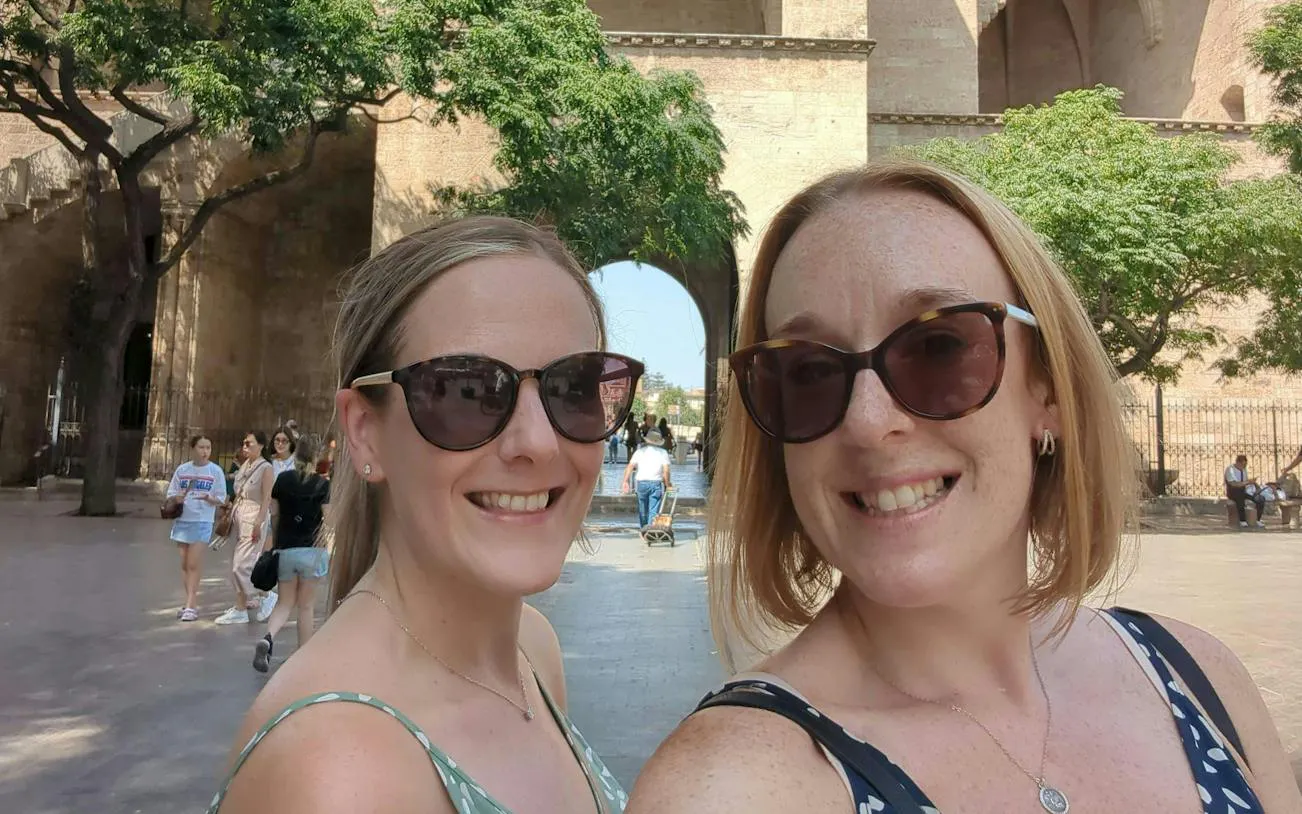 Valencia city exploration near historic archway, part of Holy Grail self-guided tour.