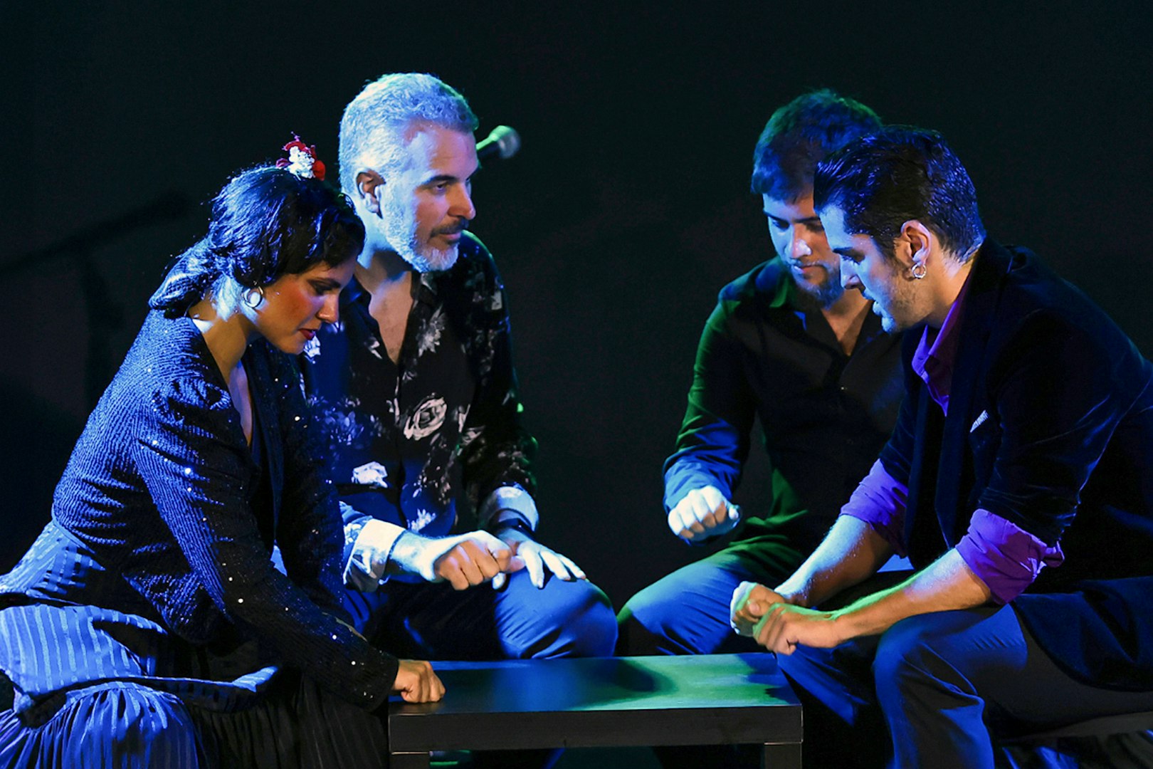 Performers at Tablao Flamenco Alma engaged in a rhythmic hand-clapping sequence.