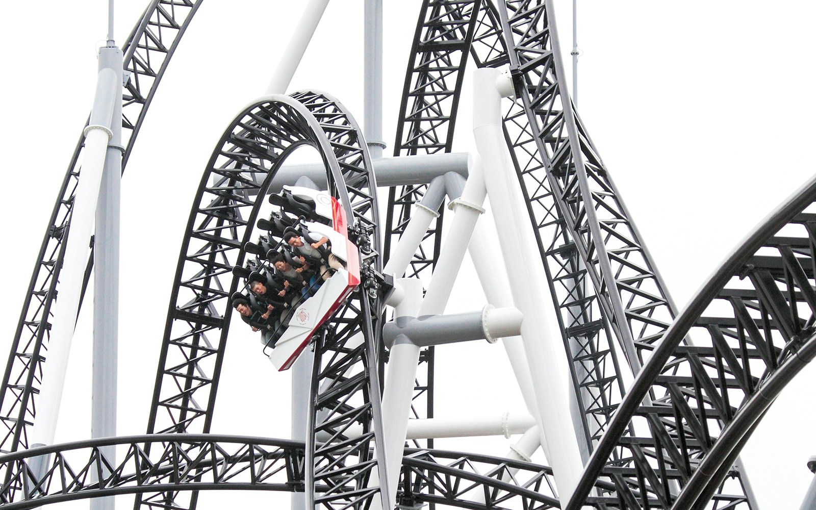 Roller coaster loop with riders at Fuji-Q Highland, Japan.