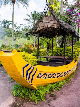 Yellow boat structure in South East Botanical Gardens surrounded by lush greenery.