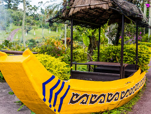 Yellow boat structure in South East Botanical Gardens surrounded by lush greenery.