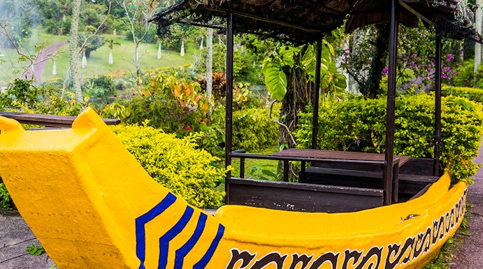 Yellow boat structure in South East Botanical Gardens surrounded by lush greenery.