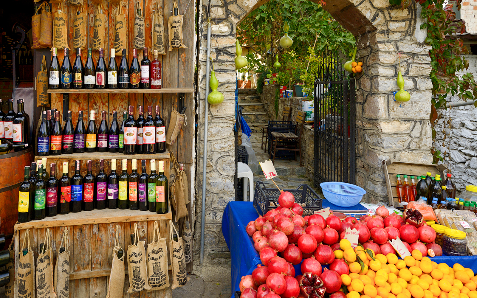 Wine bottles and fresh produce at a shop during Vineyard & Wine Tasting tour in Cappadocia.