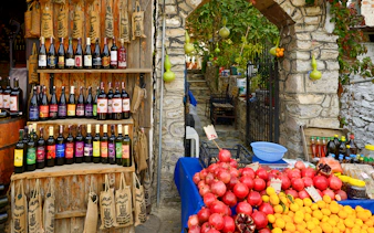 Wine bottles and fresh produce at a shop during Vineyard & Wine Tasting tour in Cappadocia.