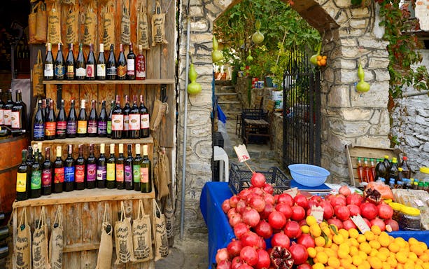 Wine bottles and fresh produce at a shop during Vineyard & Wine Tasting tour in Cappadocia.