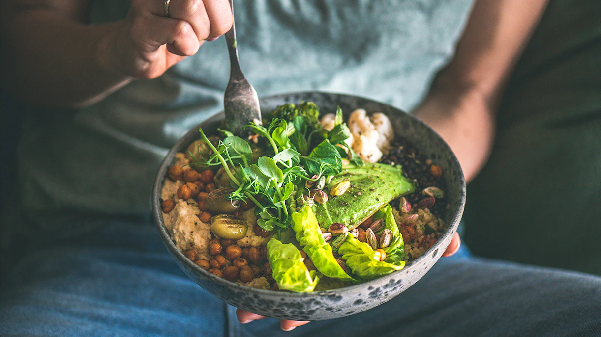 Healthy meal with chickpeas, avocado, greens, and seeds in a bowl, ideal for Skydive Melbourne.