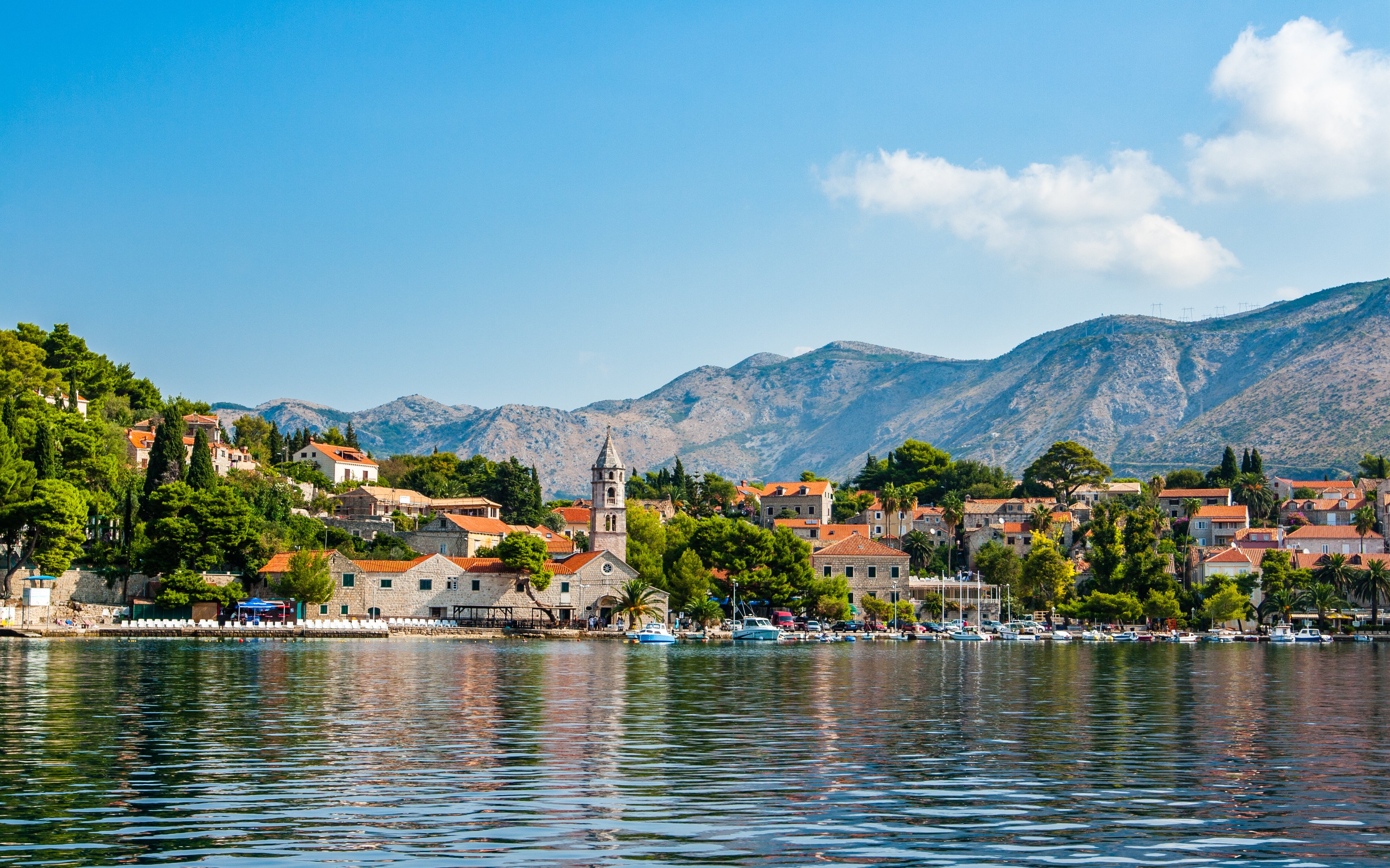 Cavtat waterfront with historic buildings and mountains in Croatia.