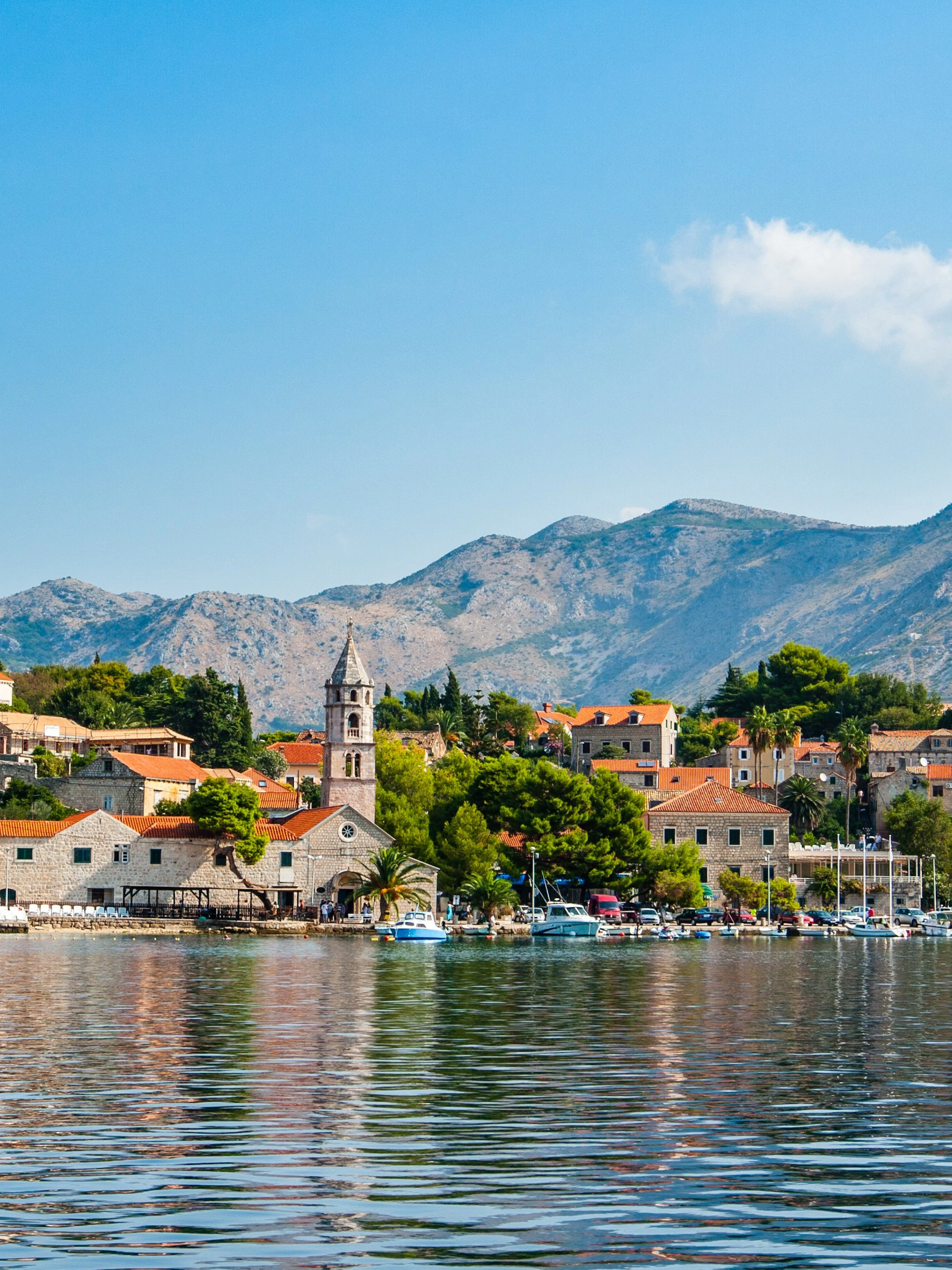 Cavtat waterfront with historic buildings and mountains in Croatia.