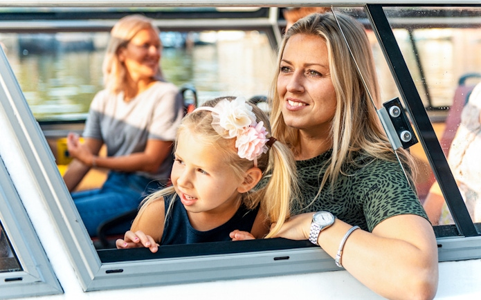 Mother and daughter enjoying Amsterdam city centre sightseeing cruise.
