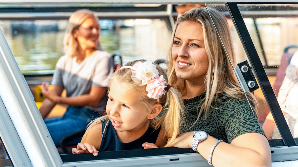 Mother and daughter enjoying Amsterdam city centre sightseeing cruise.