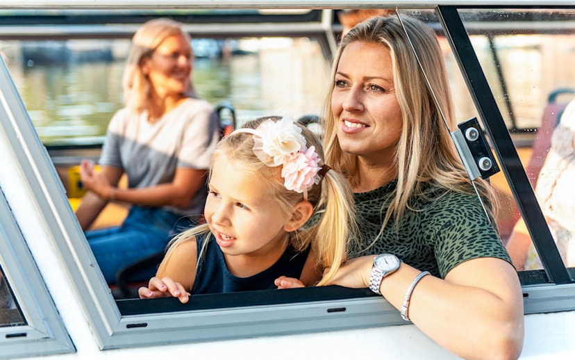 Mother and daughter enjoying Amsterdam city centre sightseeing cruise.
