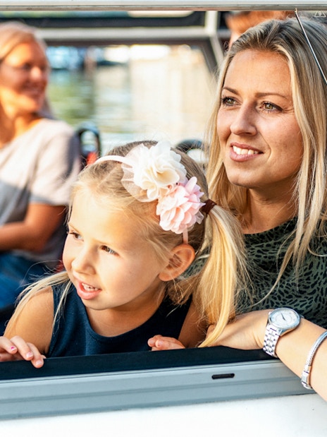 Mother and daughter enjoying Amsterdam city centre sightseeing cruise.