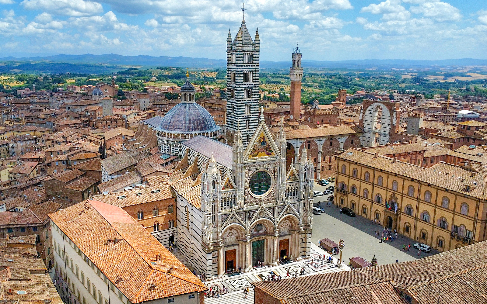 Aerial shot of the stunning Siena Cathedral facade, showcasing its unique architecture and intricate details, located in Siena, Italy