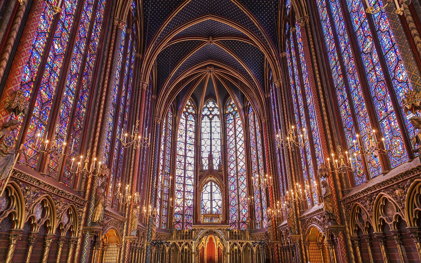 Stained glass windows and vaulted ceiling inside Sainte Chapelle, Paris.