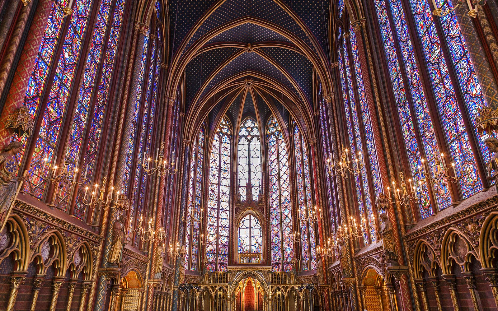 Stained glass windows and vaulted ceiling inside Sainte Chapelle, Paris.