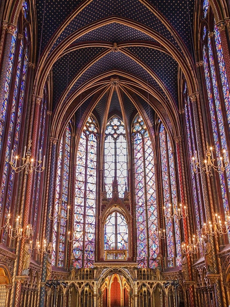 Stained glass windows and vaulted ceiling inside Sainte Chapelle, Paris.