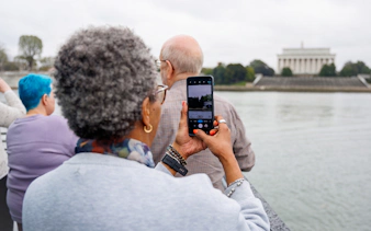 Guests capturing the Lincoln Memorial view during a brunch cruise in Washington DC.