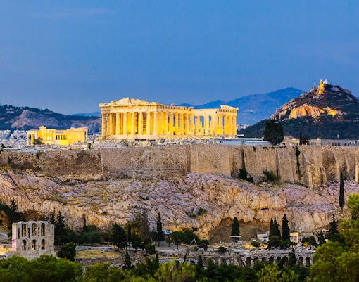 Acropolis and Parthenon illuminated after sunset in Athens, Greece.