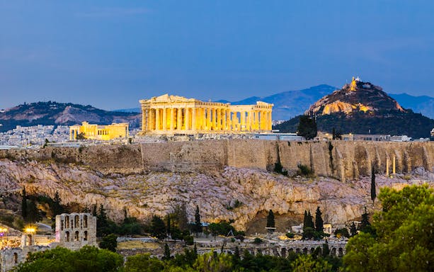Acropolis and Parthenon illuminated after sunset in Athens, Greece.