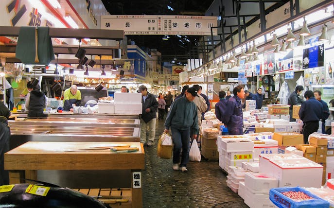 Tsukiji Outer Market vendors and shoppers during breakfast tour in Tokyo, Japan.