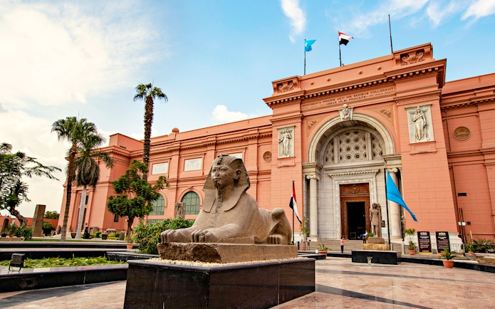 Sphinx statue in front of the Egyptian Museum entrance in Cairo, Egypt.