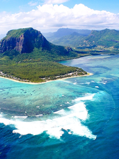 Aerial view of Le Morne Brabant mountain and turquoise waters in Mauritius during a seaplane tour.
