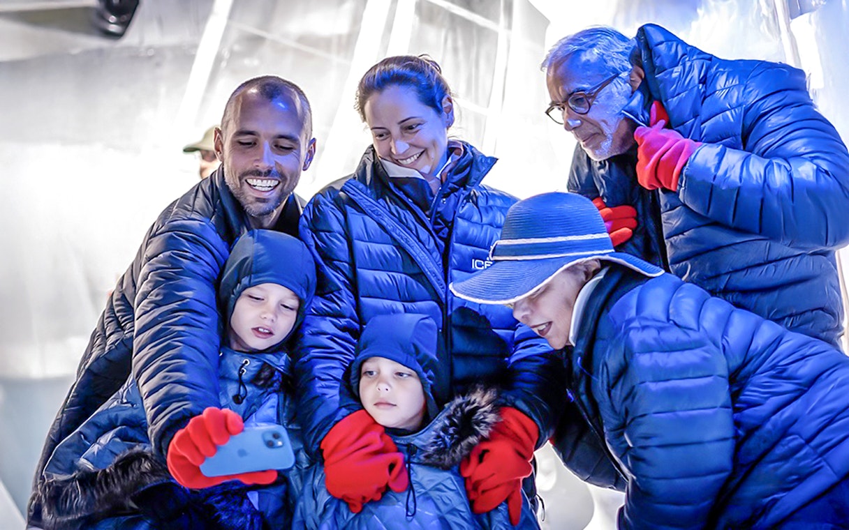 Guests taking a selfie at Berlin Icebar wearing winter coats and gloves.