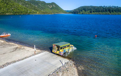 Amphibious vehicle entering Lake Rotorua during city and lakes tour.