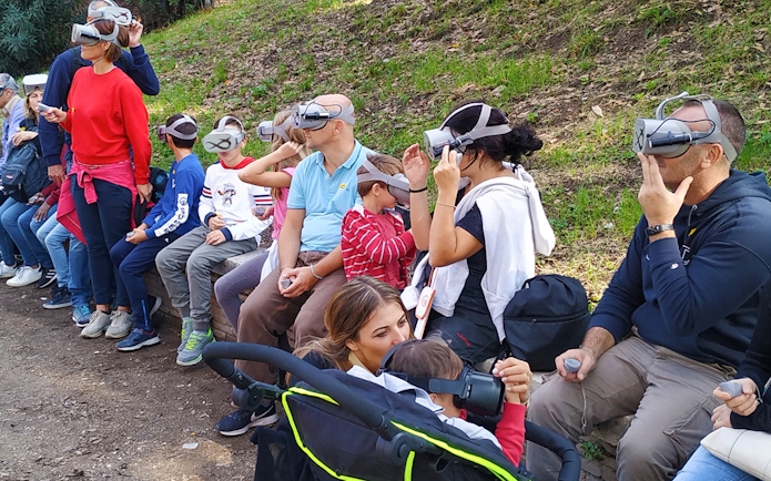 Visitors using VR headsets for a Colosseum virtual reality tour in Rome.