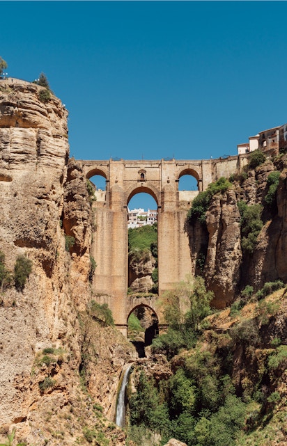 Puente Nuevo bridge spanning El Tajo Canyon with waterfall in Ronda, Malaga, Spain.