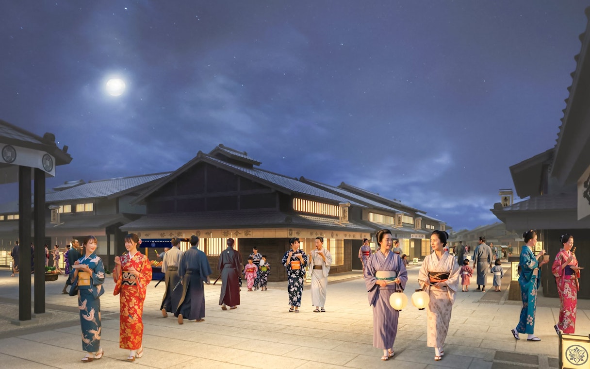 Night scene at TOEI Kyoto Studio Park with people in traditional kimonos walking under a full moon.