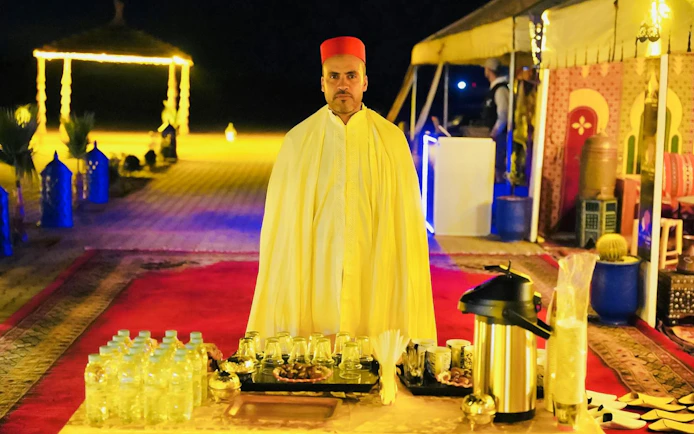 Marrakech pre-dawn hot air balloon tour setup with traditional refreshments.