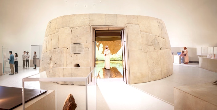 Zayed National Museum exhibit with visitors exploring ancient artifacts, Abu Dhabi.